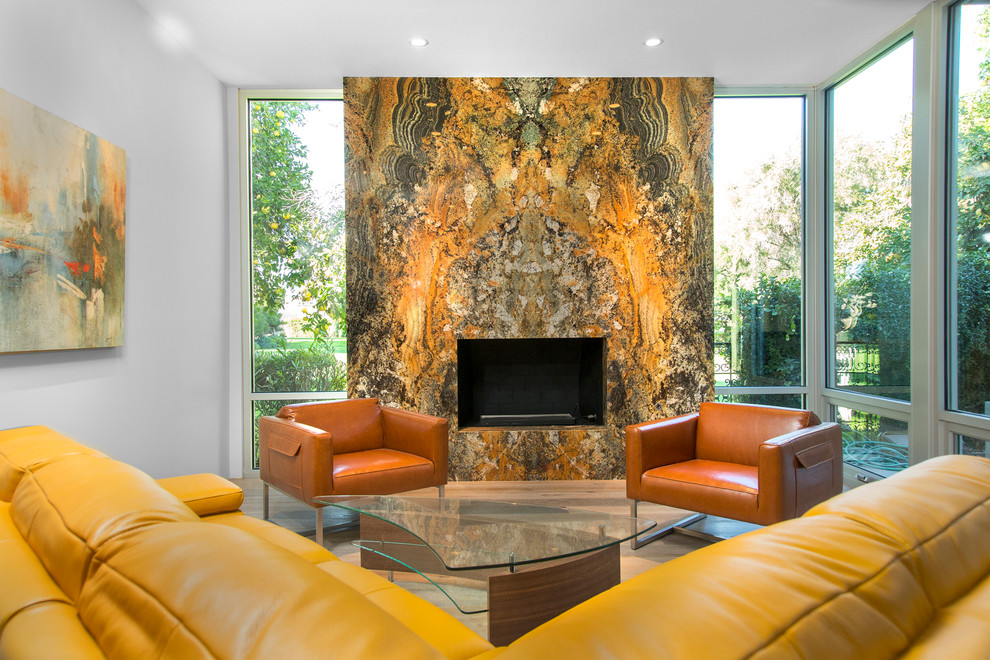 Example of a mid-sized trendy formal and enclosed light wood floor living room design in Phoenix with white walls, a standard fireplace, a stone fireplace and no tv