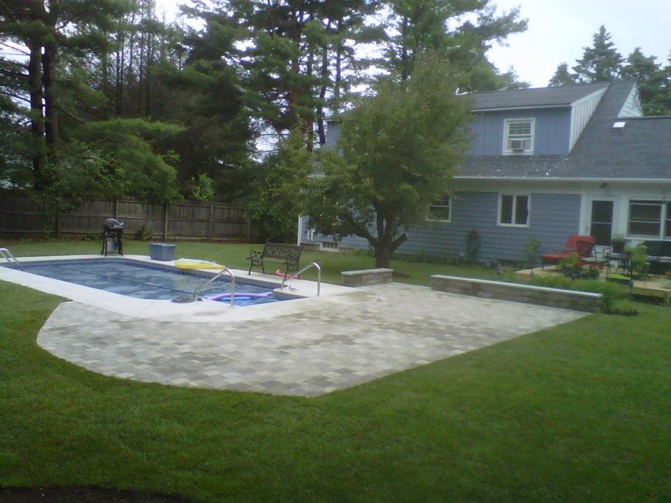 Inspiration for a mid-sized transitional backyard stone and rectangular lap pool remodel in Boston