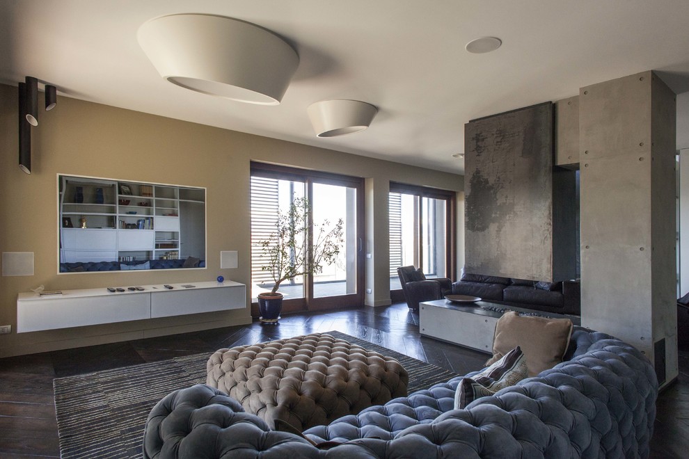 Inspiration for a large contemporary open concept family room in Turin with dark hardwood floors, a two-sided fireplace and a concrete fireplace surround.