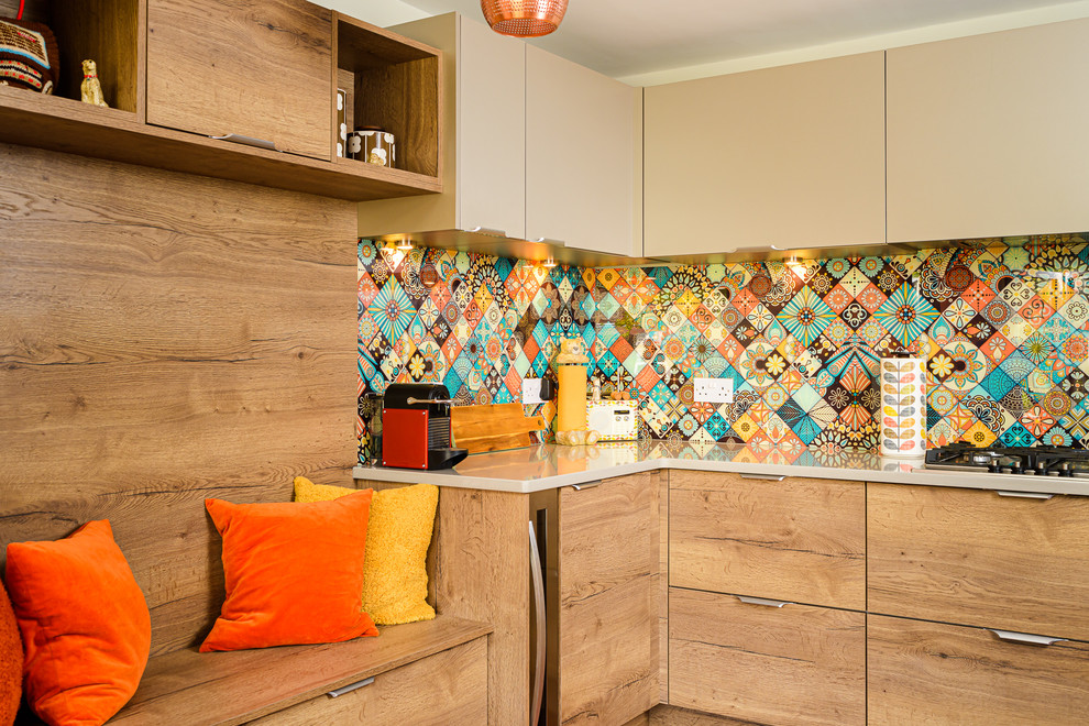 This is an example of a small midcentury l-shaped kitchen in Other with flat-panel cabinets, quartzite benchtops, multi-coloured splashback, beige cabinets and beige benchtop.