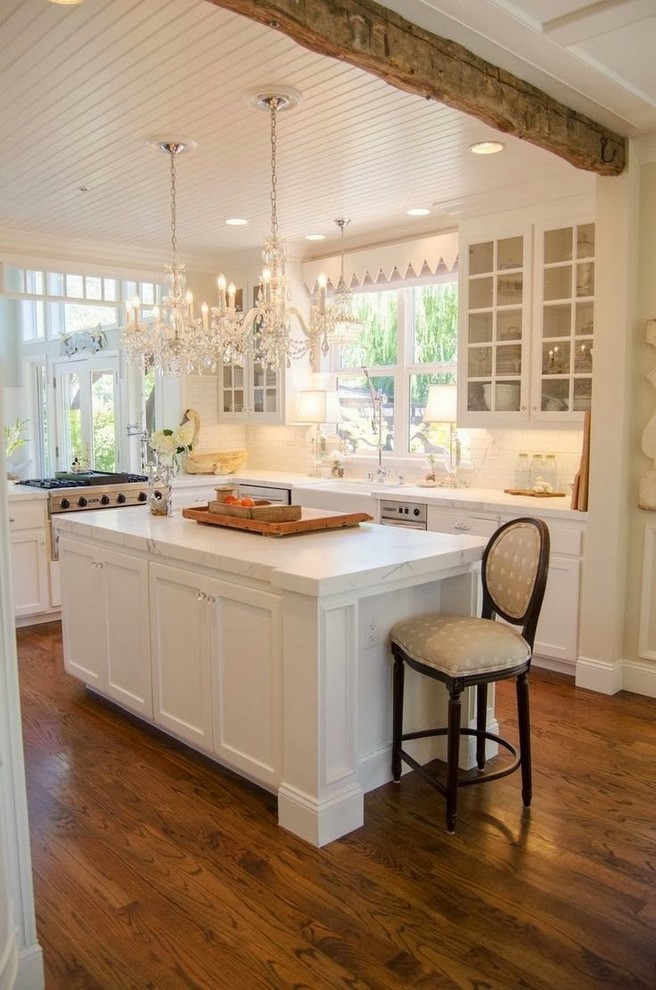 Design ideas for a traditional u-shaped kitchen in Wilmington with white cabinets.