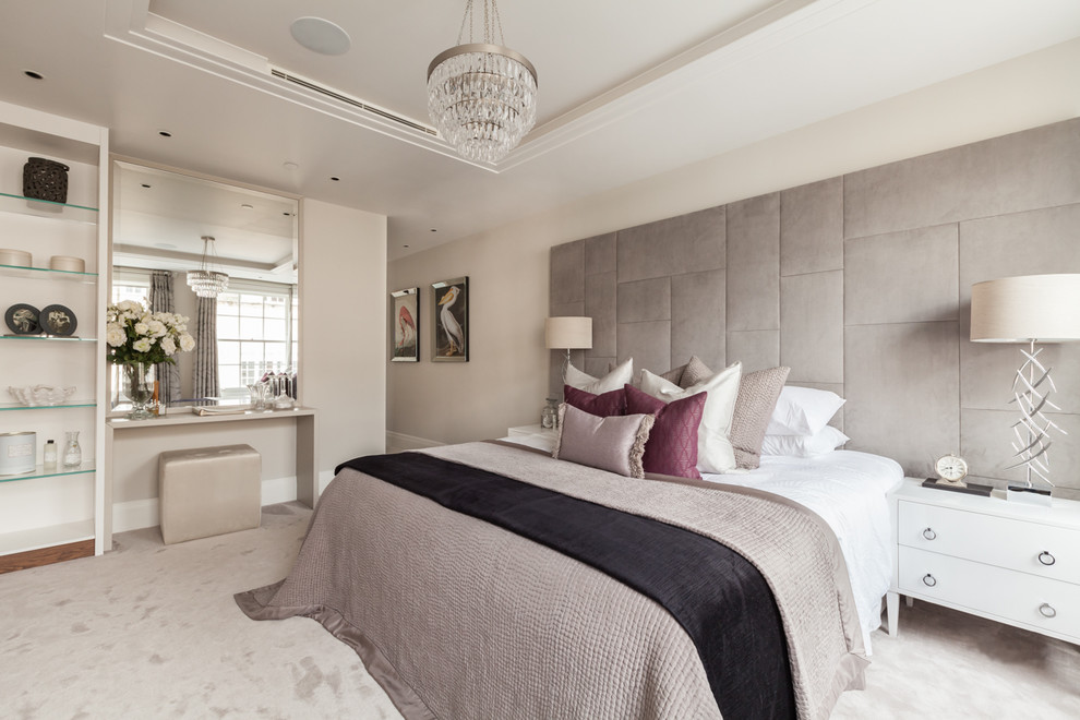 Contemporary master bedroom in London with beige walls, carpet and beige floor.