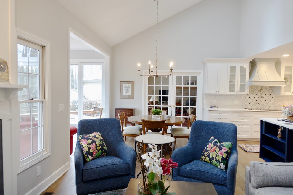 Inspiration for a large transitional galley medium tone wood floor and brown floor eat-in kitchen remodel in Cleveland with an undermount sink, shaker cabinets, white cabinets, quartzite countertops, white backsplash, subway tile backsplash, stainless steel appliances and a peninsula