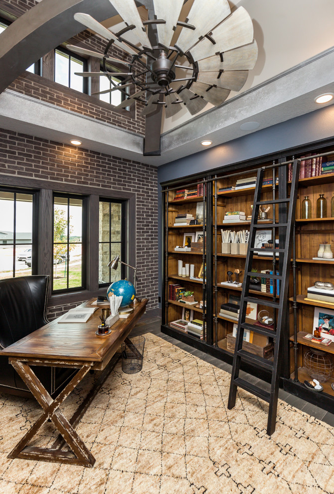 Mid-sized industrial study room in Other with grey walls, dark hardwood floors, no fireplace, a freestanding desk and brown floor.