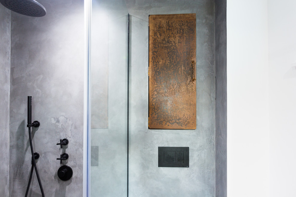 Design ideas for an industrial 3/4 bathroom in London with a corner shower, grey walls and concrete floors.
