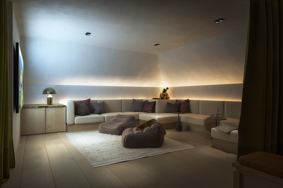 Inspiration for an expansive contemporary open plan home cinema in Dublin with beige walls, light hardwood flooring, a wall mounted tv and beige floors.