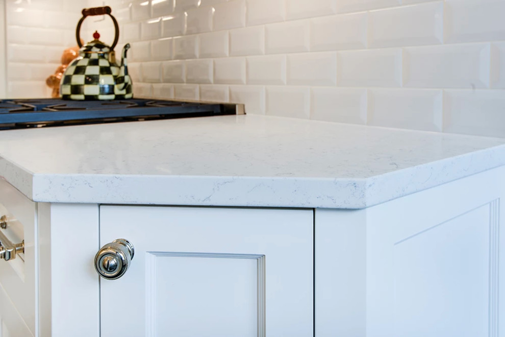 Inspiration for a mid-sized transitional u-shaped gray floor eat-in kitchen remodel with an undermount sink, shaker cabinets, white cabinets, stainless steel appliances and no island