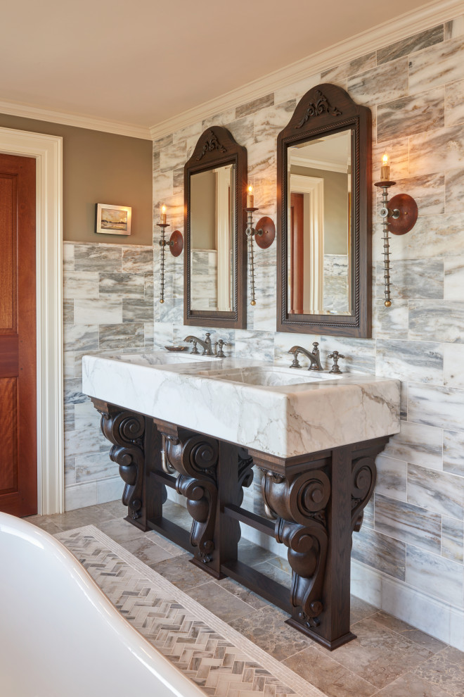 This is an example of a large master bathroom in Boston with furniture-like cabinets, dark wood cabinets, a claw-foot tub, a corner shower, a one-piece toilet, multi-coloured tile, marble, brown walls, marble floors, an integrated sink, marble benchtops, multi-coloured floor, a hinged shower door, white benchtops, an enclosed toilet, a double vanity and a built-in vanity.