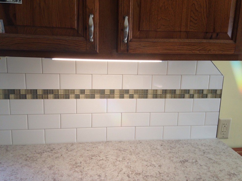 Inspiration for a transitional kitchen remodel in Boston with raised-panel cabinets, dark wood cabinets, granite countertops, white backsplash and subway tile backsplash