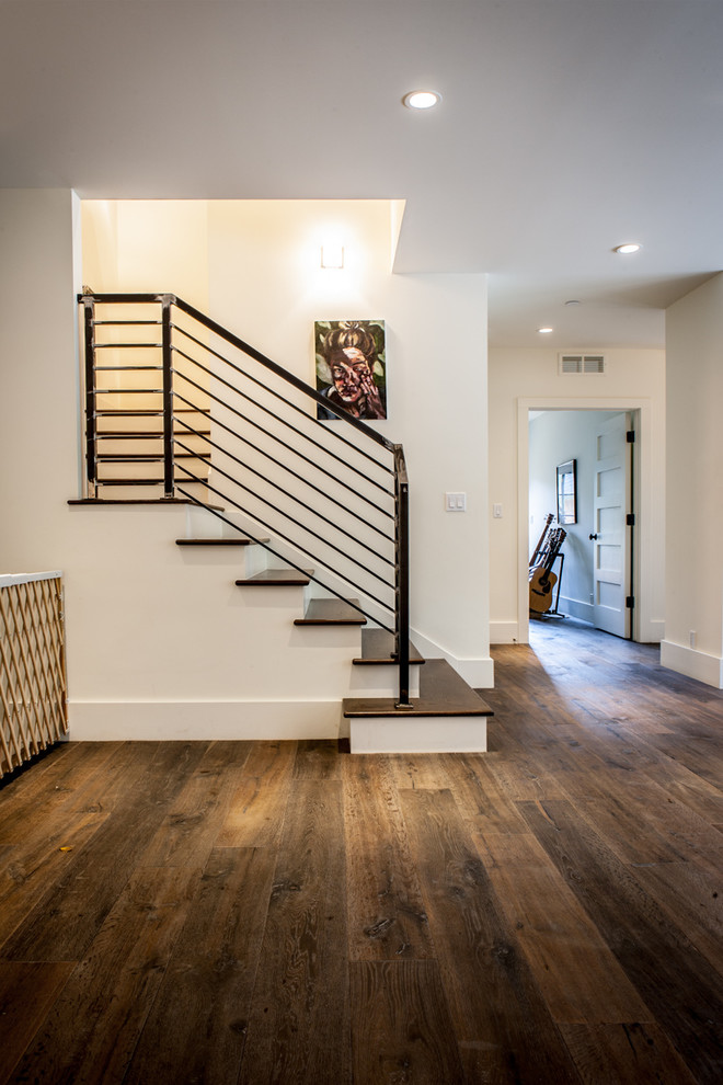Design ideas for a mid-sized country wood u-shaped staircase in Denver.