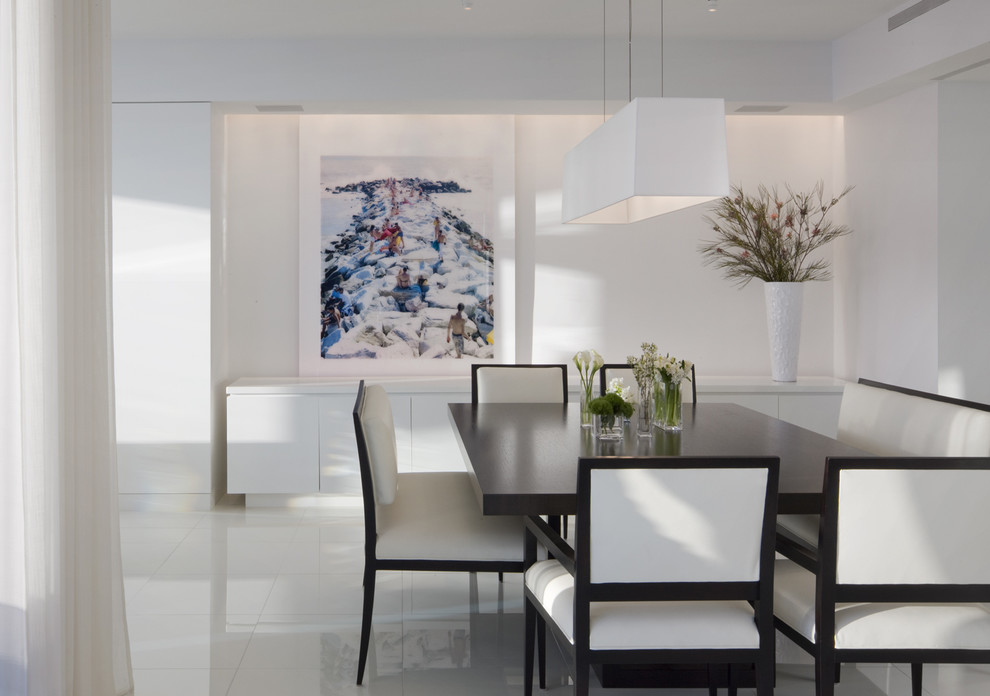Photo of a contemporary dining room in Miami with white walls and white floor.