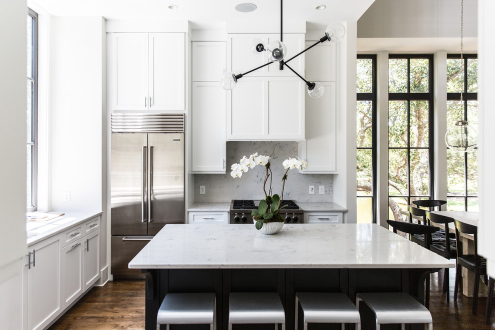 Photo of a transitional eat-in kitchen in Charleston with shaker cabinets, white splashback, stainless steel appliances, dark hardwood floors, with island and brown floor.