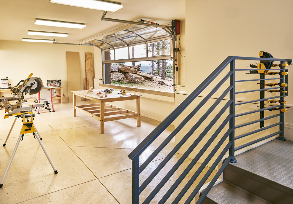 Inspiration for a large rustic attached garage workshop remodel in Denver