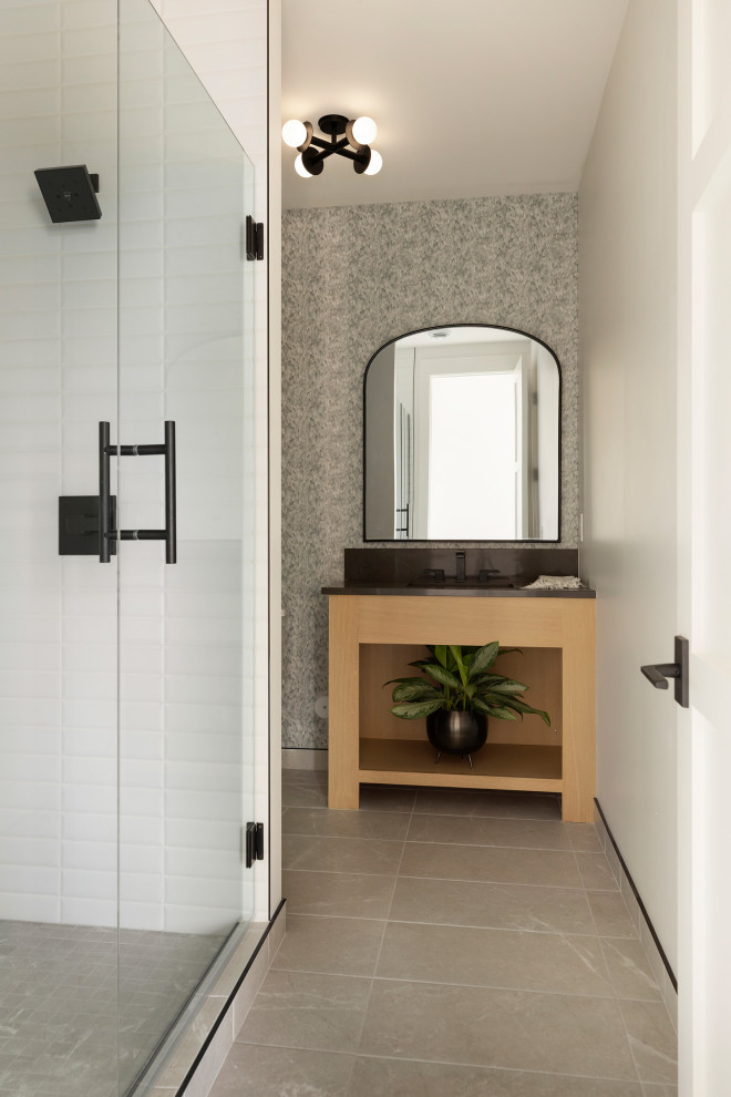 Photo of a transitional bathroom in Minneapolis with white tile, marble, with a sauna, engineered quartz benchtops, grey floor, a hinged shower door, black benchtops, a single vanity, a built-in vanity and wallpaper.