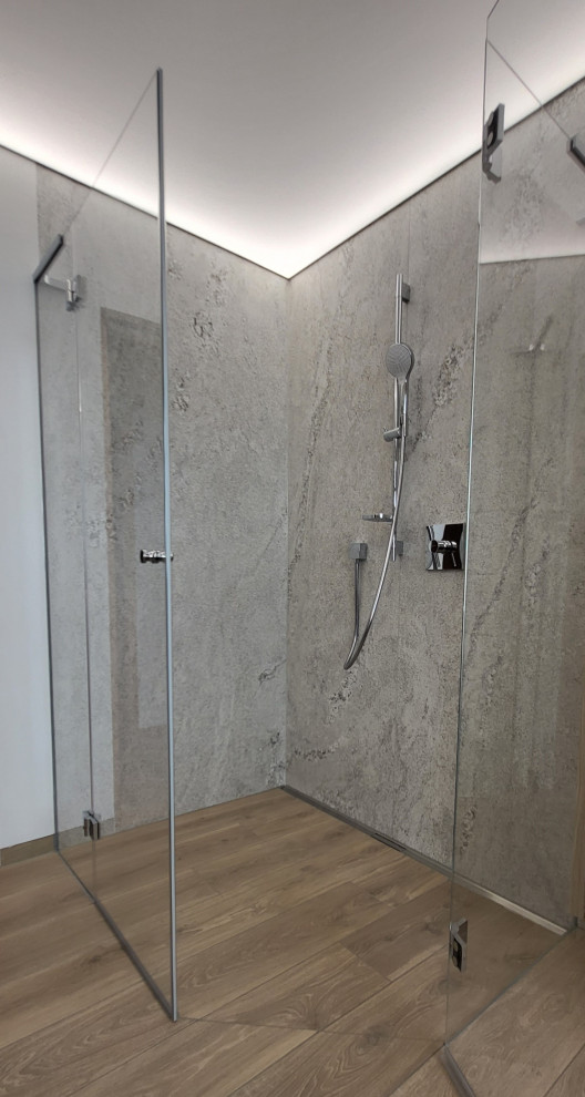 Photo of a large contemporary bathroom in Frankfurt with a curbless shower, gray tile, stone tile, white walls, wood-look tile, brown floor and recessed.