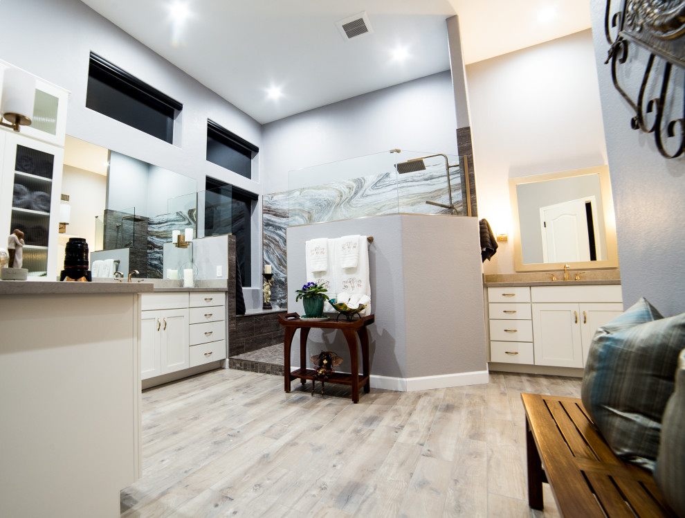 Inspiration for an expansive traditional master bathroom in Phoenix with shaker cabinets, white cabinets, an open shower, gray tile, porcelain tile, grey walls, porcelain floors, an undermount sink, quartzite benchtops, brown floor, an open shower, grey benchtops, a shower seat, a double vanity, a built-in vanity and panelled walls.