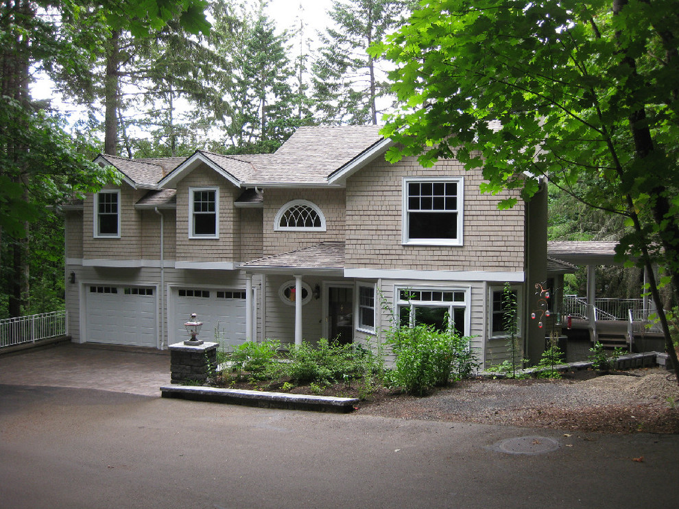 Photo of a mid-sized traditional two-storey beige exterior in Portland with wood siding and a gable roof.