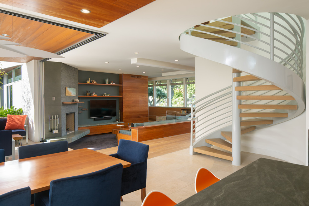Design ideas for a mid-sized tropical wood spiral staircase in San Diego with open risers and metal railing.