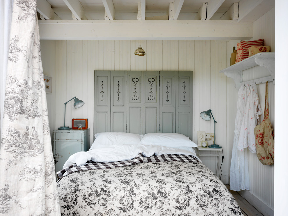 Inspiration for a beach style bedroom in London with planked wall panelling.