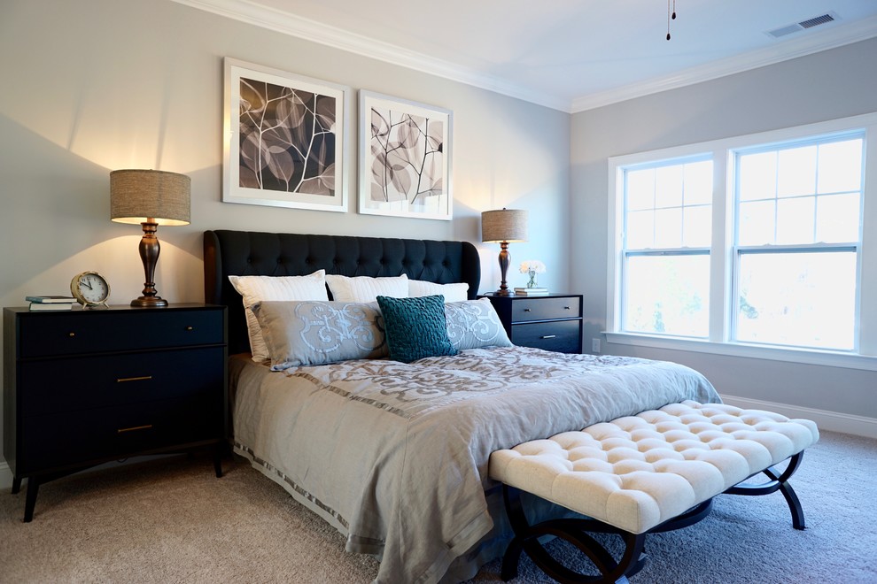 Large contemporary master bedroom in Raleigh with grey walls, carpet and no fireplace.