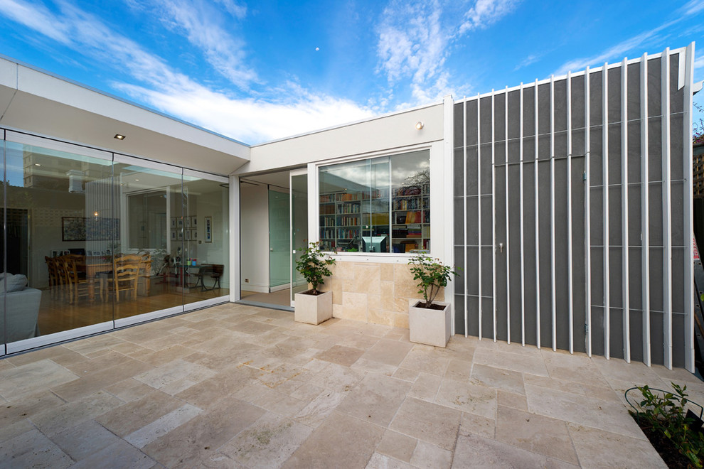 Photo of a contemporary one-storey glass exterior in Melbourne.