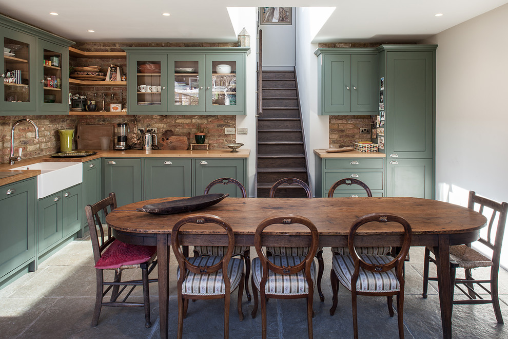 Inspiration for a transitional kitchen/dining combo in London with white walls.