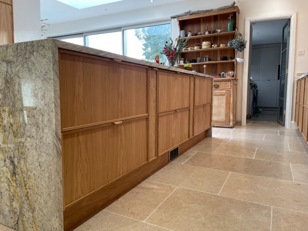 Design ideas for an expansive contemporary single-wall kitchen/diner with medium wood cabinets, quartz worktops, an island, beige floors, grey worktops and feature lighting.