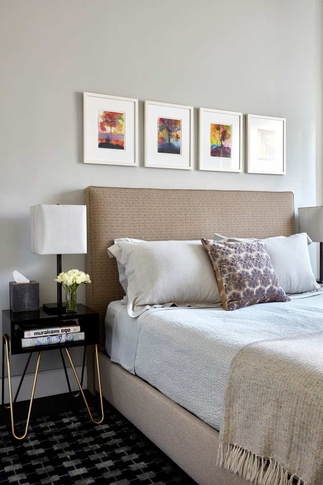 This is an example of a modern guest bedroom in New York with grey walls and dark hardwood floors.