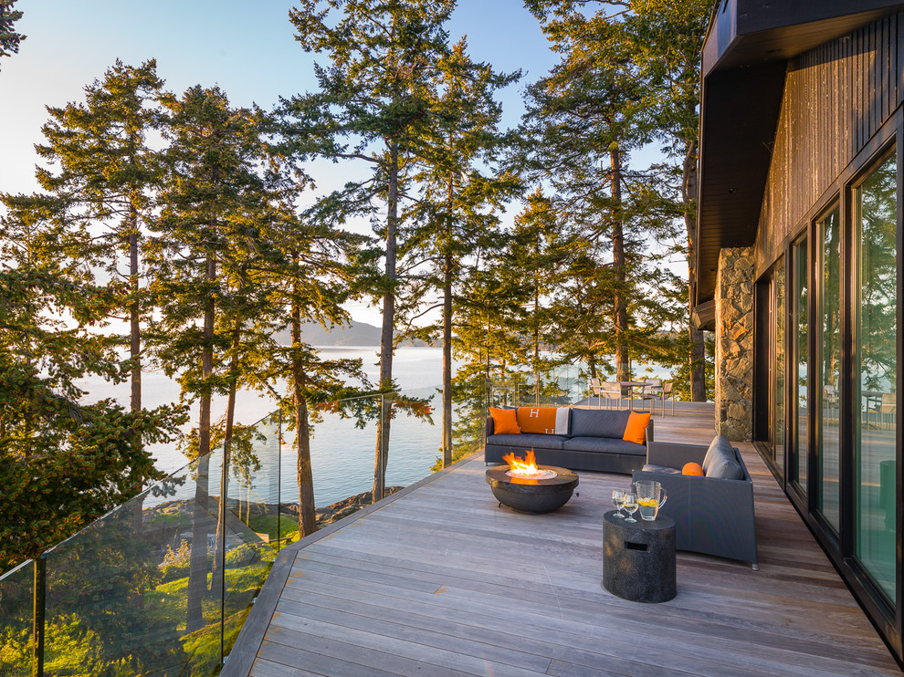 Beach style deck in Vancouver with a fire feature and no cover.