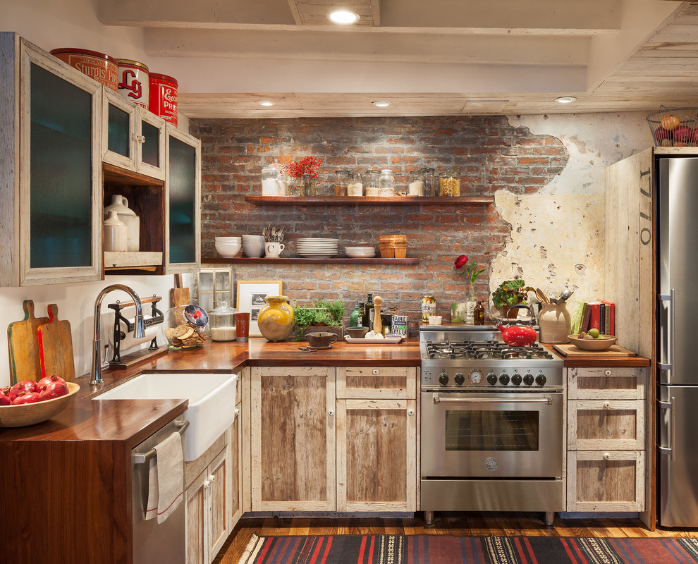 Inspiration for a small rustic l-shaped medium tone wood floor and brown floor eat-in kitchen remodel in Philadelphia with a farmhouse sink, shaker cabinets, light wood cabinets, wood countertops, red backsplash, brick backsplash, stainless steel appliances, no island and brown countertops