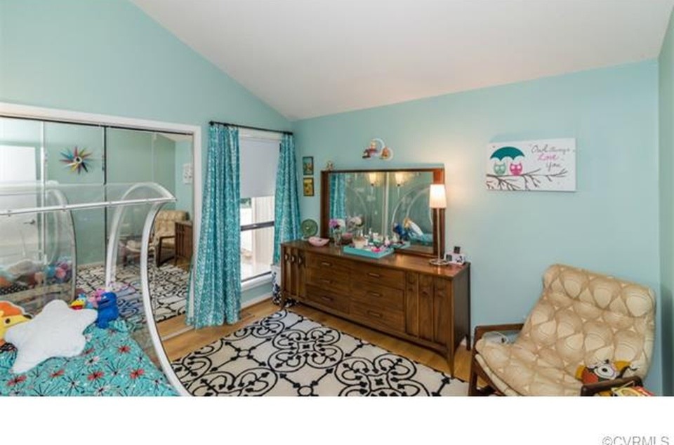 Photo of a mid-sized midcentury gender-neutral kids' room in Richmond with blue walls and medium hardwood floors.
