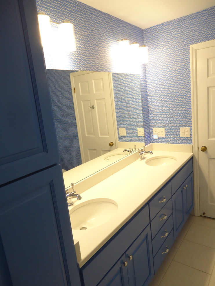 Design ideas for a mid-sized contemporary 3/4 bathroom in Milwaukee with raised-panel cabinets, blue cabinets, an alcove shower, a one-piece toilet, blue walls, porcelain floors, an undermount sink, quartzite benchtops, white floor, white tile, porcelain tile and a hinged shower door.
