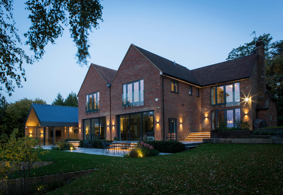 Large contemporary two-storey brick red house exterior in Buckinghamshire.