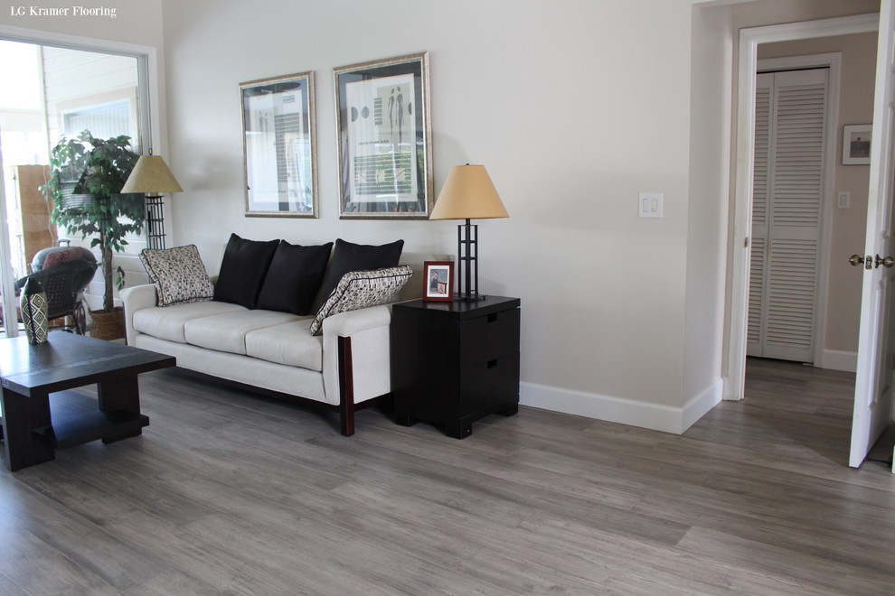 This is an example of a mid-sized traditional formal open concept living room in Tampa with beige walls, medium hardwood floors, no tv and grey floor.