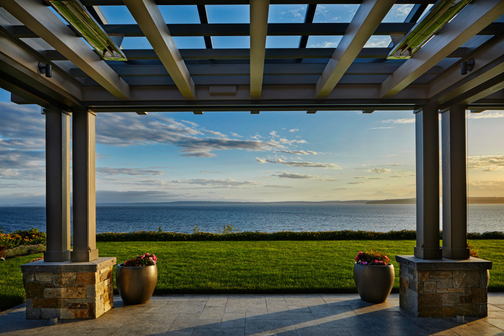 Inspiration for a transitional backyard patio remodel in Seattle with a fire pit and a roof extension
