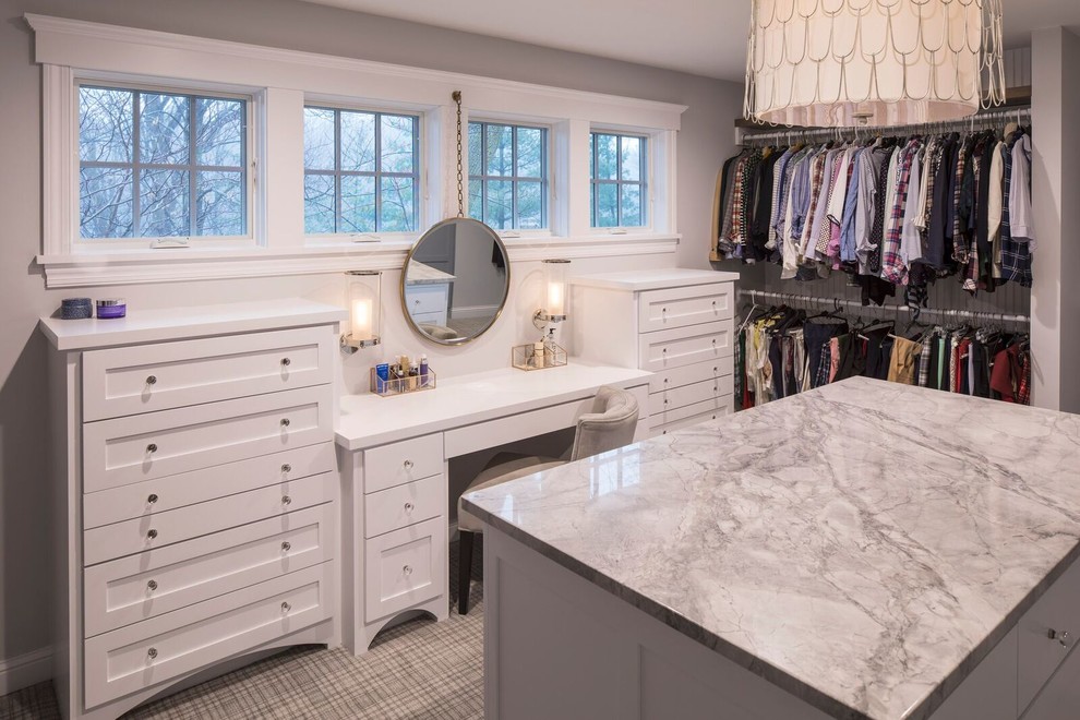 Design ideas for a large transitional gender-neutral walk-in wardrobe in Minneapolis with shaker cabinets, white cabinets and carpet.