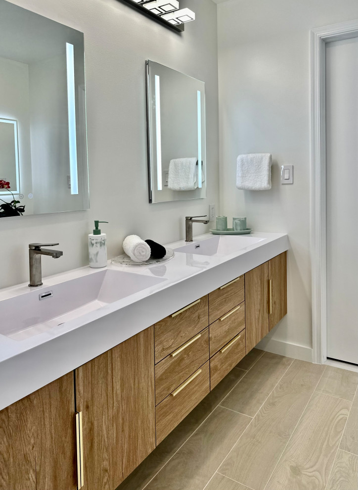 Example of a large minimalist master white tile and porcelain tile wood-look tile floor and double-sink bathroom design in Miami with flat-panel cabinets, medium tone wood cabinets, white walls, an undermount sink, solid surface countertops, white countertops and a floating vanity