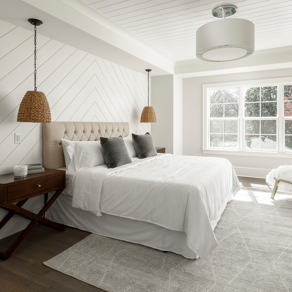Large farmhouse master brown floor and dark wood floor bedroom photo in Charlotte with gray walls