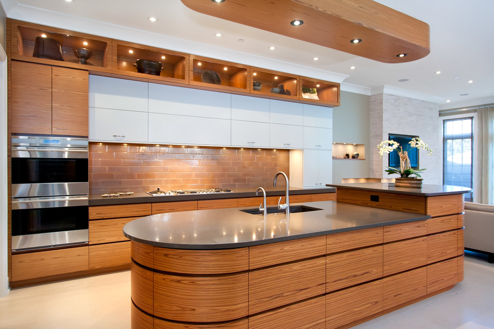 This is an example of a contemporary kitchen in Chicago with an undermount sink, flat-panel cabinets, medium wood cabinets, brown splashback and subway tile splashback.