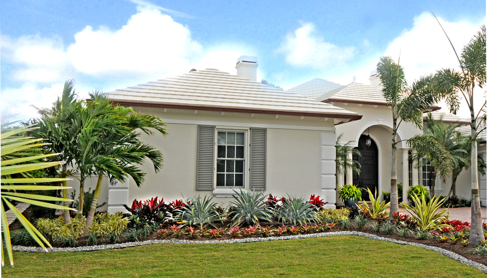 Photo of a mid-sized tropical front yard partial sun garden in Miami.