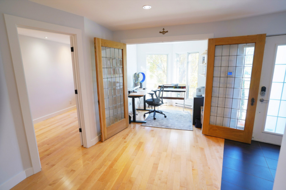 Photo of a mid-sized traditional home studio in Chicago with white walls, light hardwood floors and a freestanding desk.