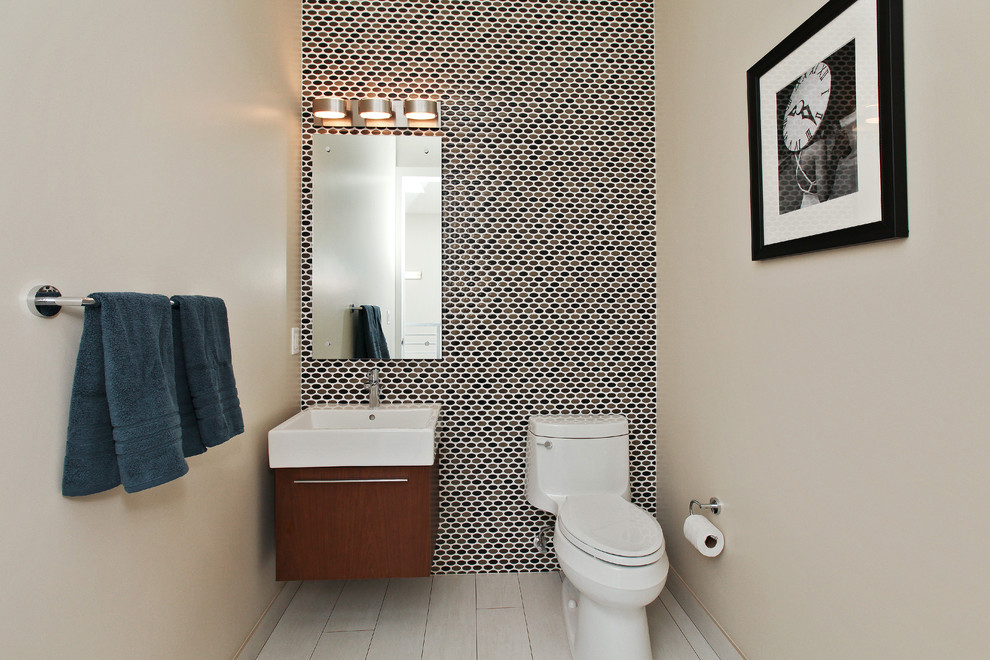 Contemporary powder room in San Francisco with flat-panel cabinets, dark wood cabinets, mosaic tile and a wall-mount sink.