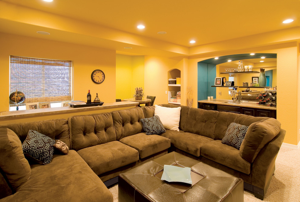 Inspiration for a large transitional look-out basement in Denver with yellow walls, carpet, no fireplace and beige floor.