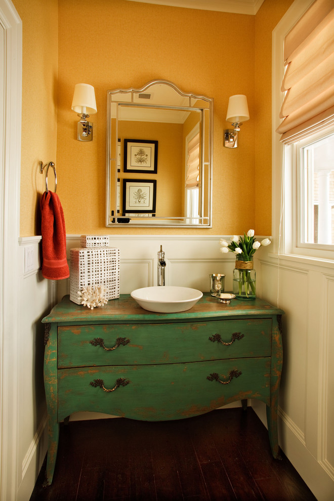 Small traditional powder room in Portland with a vessel sink, furniture-like cabinets, green cabinets and dark hardwood floors.