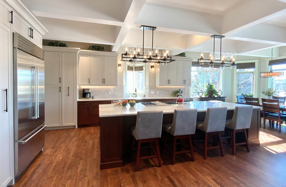 Example of a large transitional single-wall dark wood floor, brown floor and coffered ceiling eat-in kitchen design in Calgary with an undermount sink, shaker cabinets, gray cabinets, quartzite countertops, multicolored backsplash, stone slab backsplash, stainless steel appliances, an island and multicolored countertops