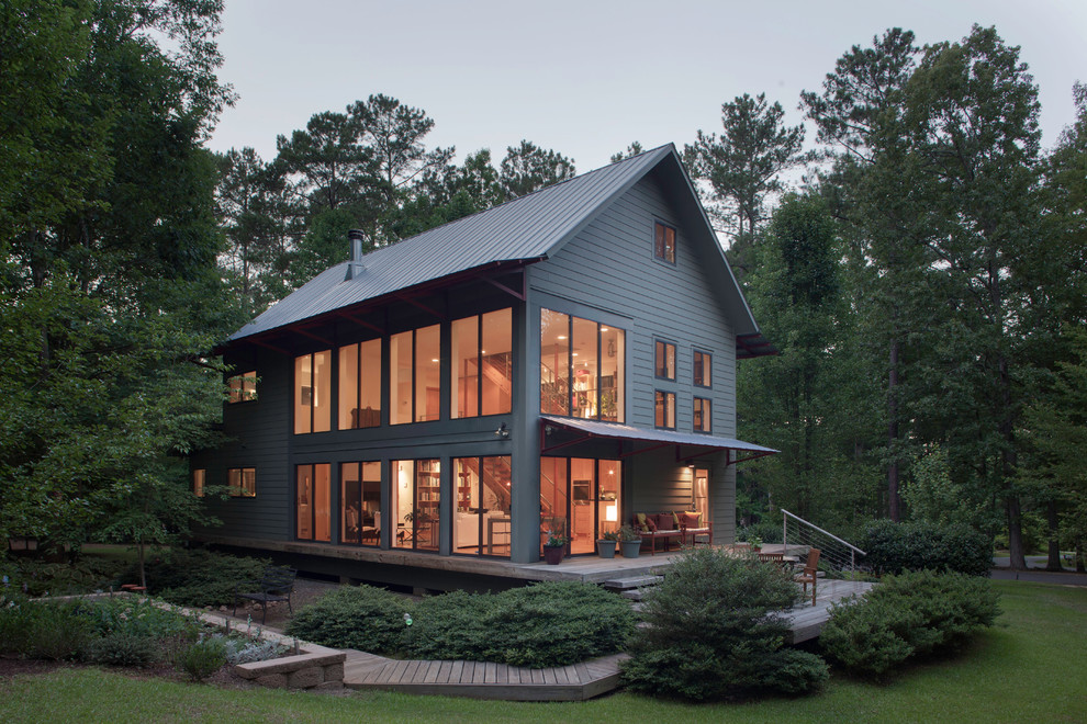 Design ideas for a contemporary two-storey green exterior in Raleigh with concrete fiberboard siding.