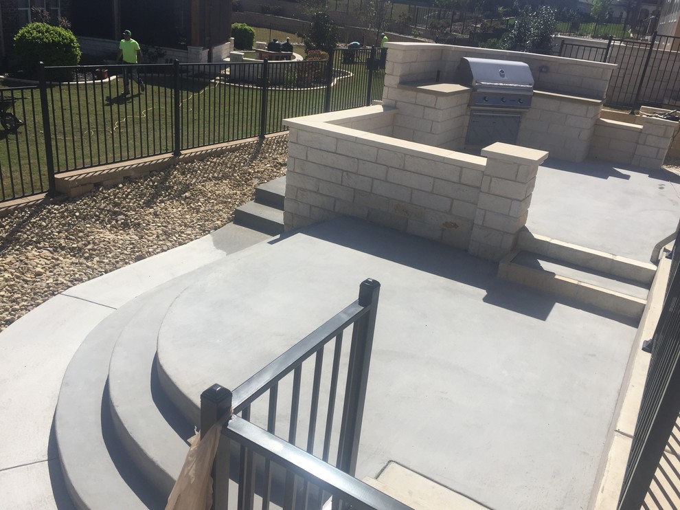 New multi-leveled concrete patio w/ limestone walls and outdoor kitchen