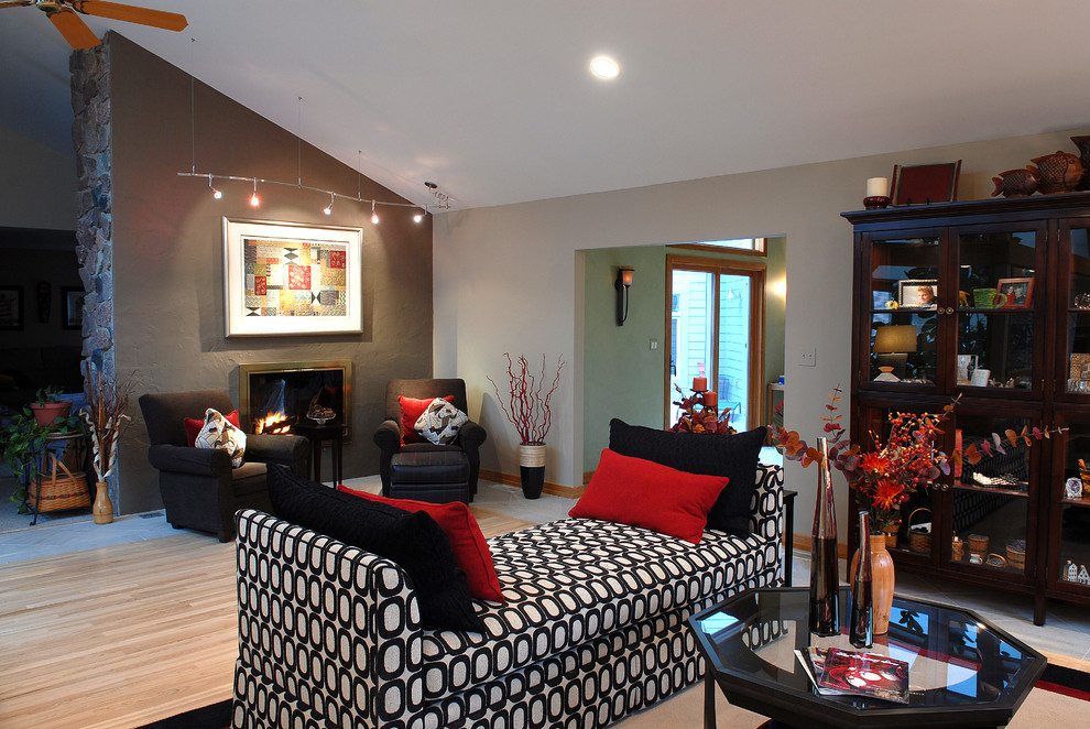 This is an example of a medium sized contemporary formal living room in Chicago with light hardwood flooring, brown floors and a vaulted ceiling.