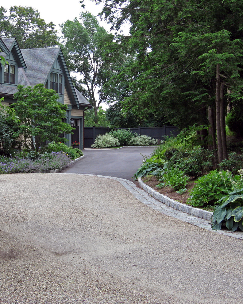 Design ideas for a large traditional front yard partial sun driveway in Boston with gravel.