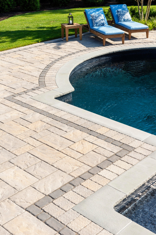 Design ideas for a traditional backyard pool in New York with concrete pavers.